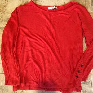 Two knit long sleeve tops with button detail on sleeves